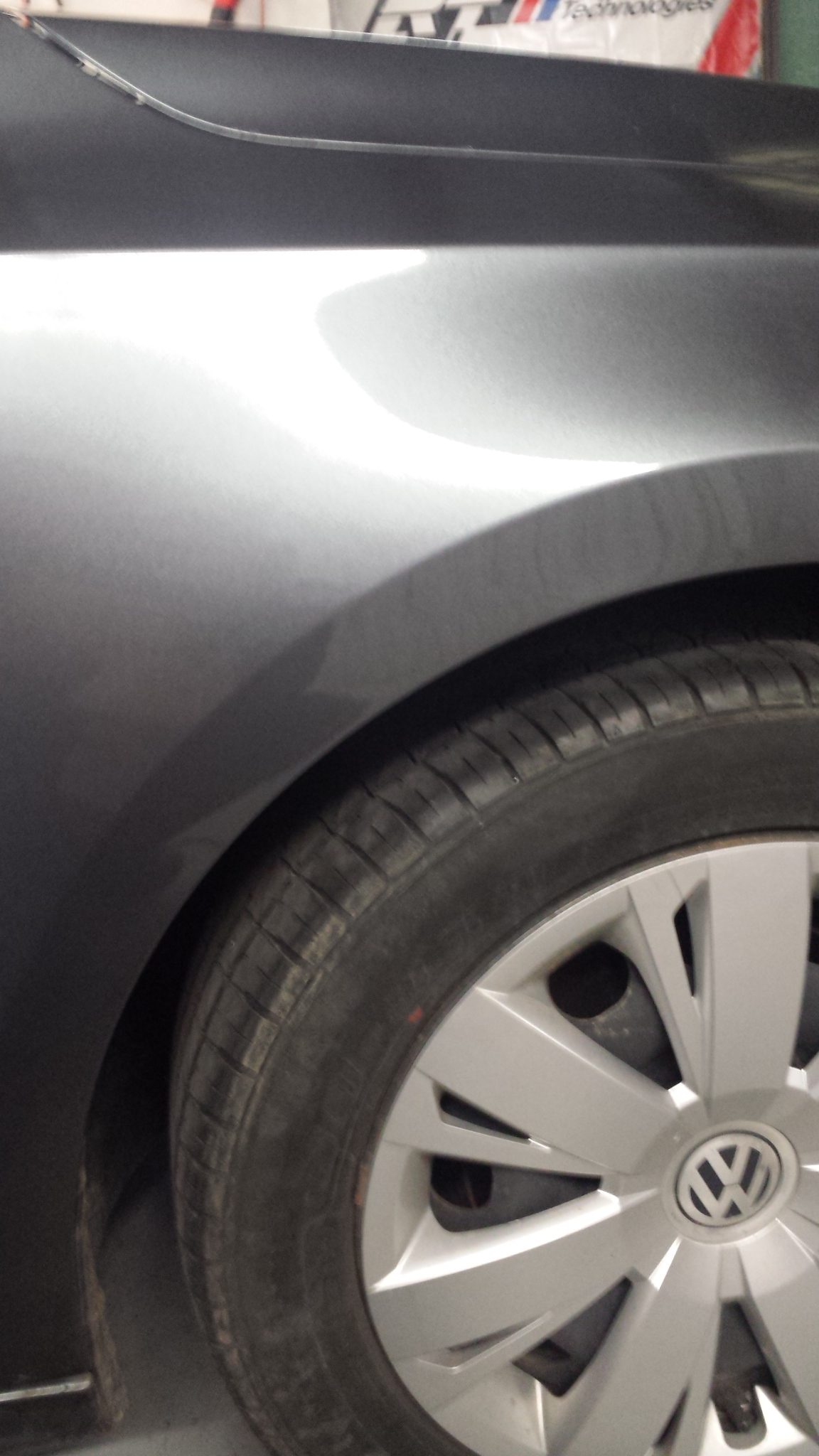 The same Volkswagen rear quarter panel after repair, reflection lines straight