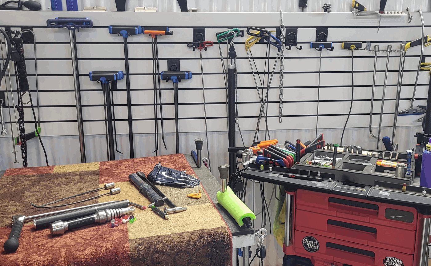 The Repair Technologies workbench in Omaha with paintless dent repair rods and tools